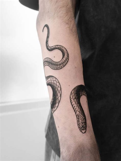 snake tattoo wrapped around arm.